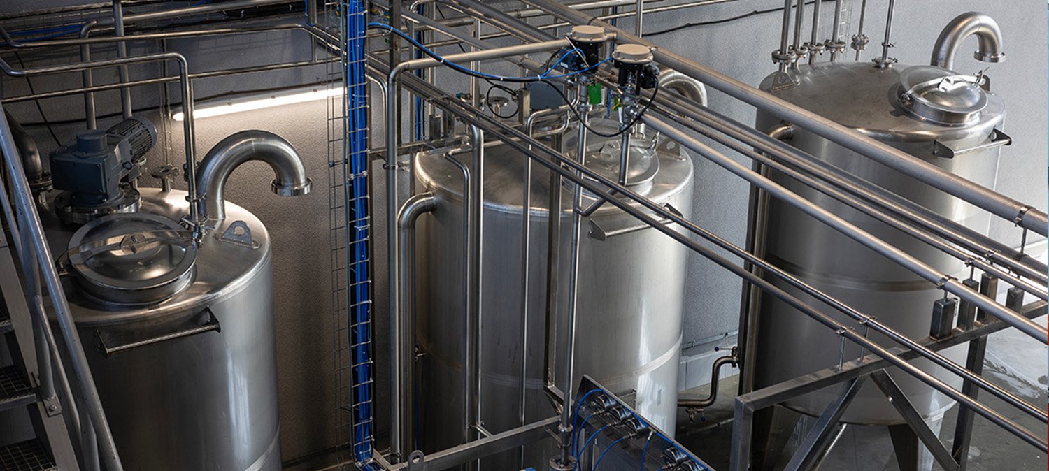 Stainless process pipework and tanks in a food and beverage production facility